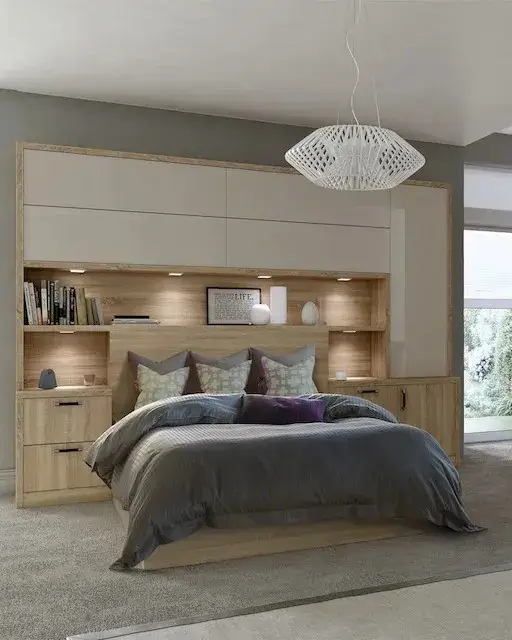 Fitted bedroom with overhead storage and bedside units around the bed